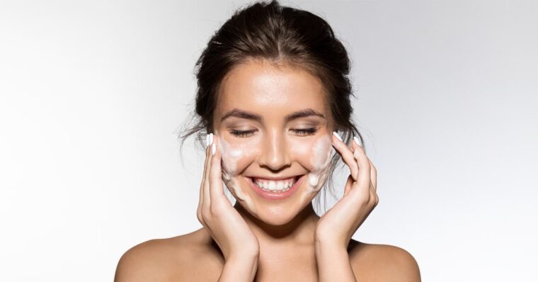 Woman applying natural skincare product - Leafoberryy skin care